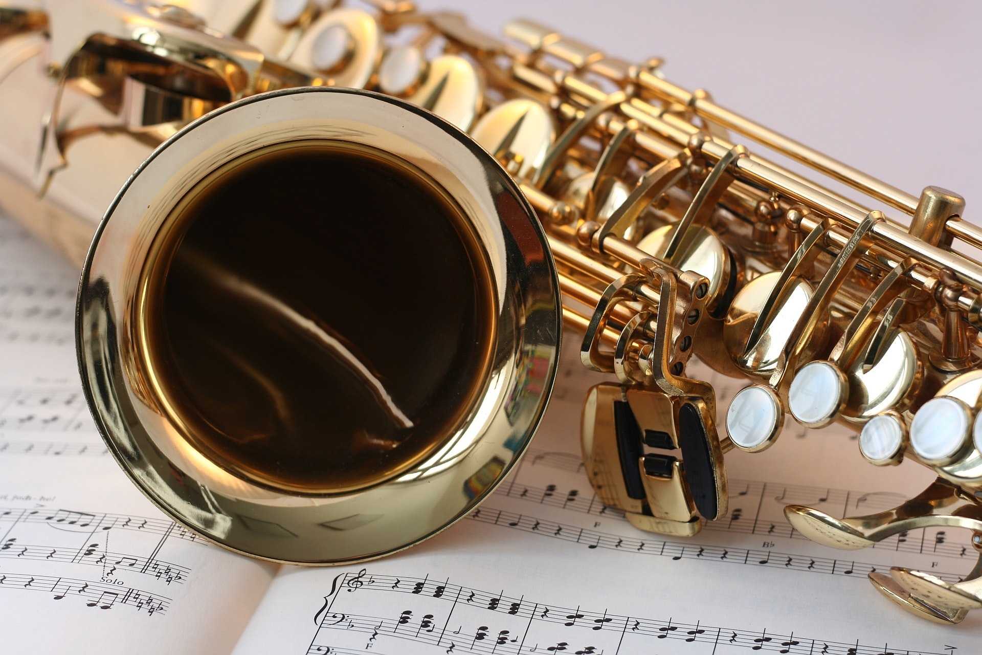 Saxophone lying on sheet music